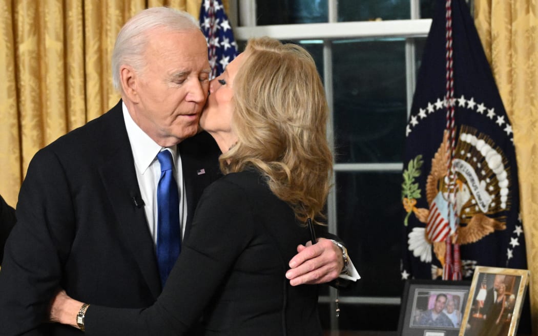 First Lady Jill Biden kisses her husband US President Joe Biden after he delivered his farewell address to the nation from the Oval Office of the White House in Washington, DC, on January 15, 2025. (Photo by Mandel NGAN / POOL / AFP)