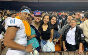 Samoan teenager Belford Viali poses with family following the Polynesian Bowl.
