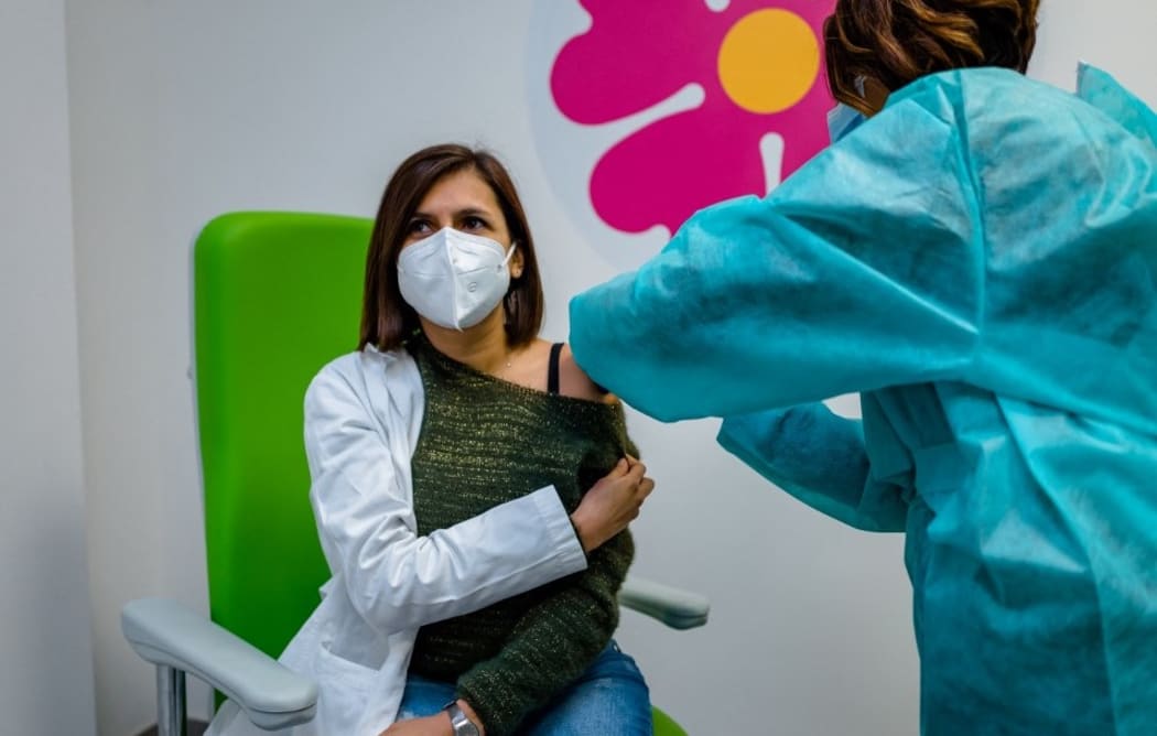 A doctor who works in the vaccination hub is given the third dose of the anticovid vaccine at the Cozzoli vaccine hub in Molfetta on November 24, 2021.