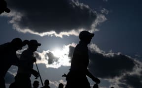 Rory MCILROY (R)  walks off 18th tee during the US Masters.