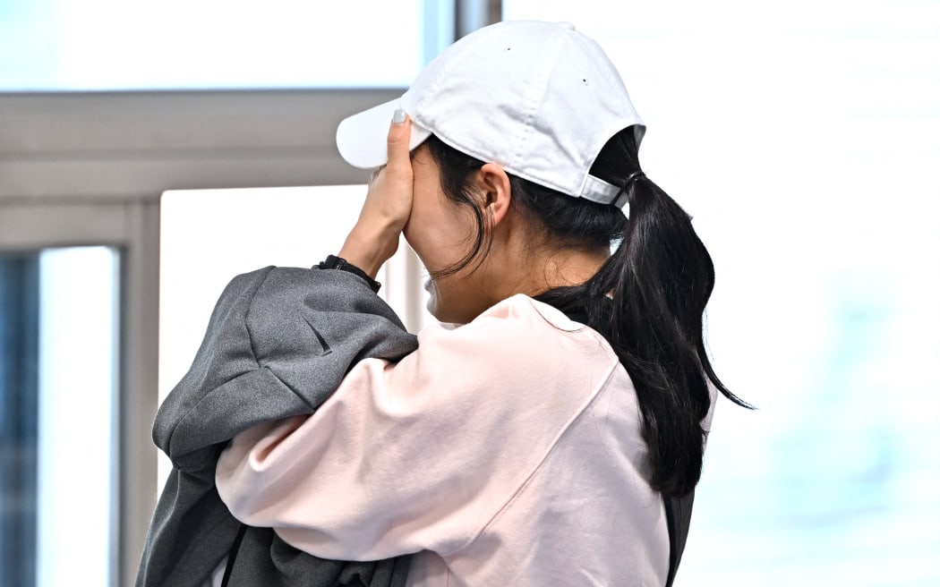 A relative of missing persons following the Itaewon Halloween stampede reacts as she waits for updates at the Hannam-dong Community Center in Seoul on October 30, 2022. - More than 150 people were killed and scores more injured in a stampede at a packed Halloween event in central Seoul late on October 29, officials said, in one of South Korea's worst peacetime accidents. (Photo by Jung Yeon-je / AFP)