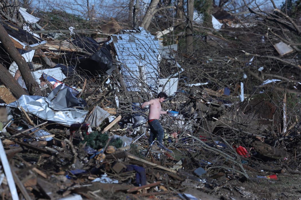 Residents continue to salvage belongings from destroyed homes after a tornado tore through a large section of the city late Friday evening on December 12, 2021 in Mayfield, Kentucky.