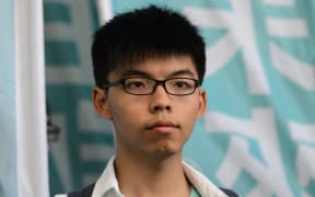 Pro-democracy political activist and member of the Demosisto party Joshua Wong looks on after leaving the Eastern Court in Hong Kong on July 21, 2016.