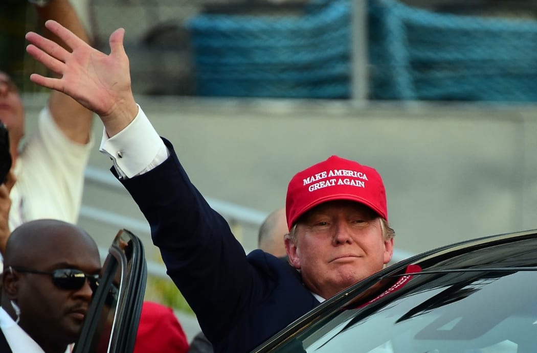 Republican Presidential candidate Donald Trump waves as leaves following a speech on board the Worl War II bettlaship USS Iowa in San Pedro, California on September 15, 2015.