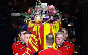 The coffin of Queen Elizabeth II is carried out of the Westminster Abbey in London.
