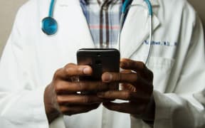 Image of a doctor holding a smart phone