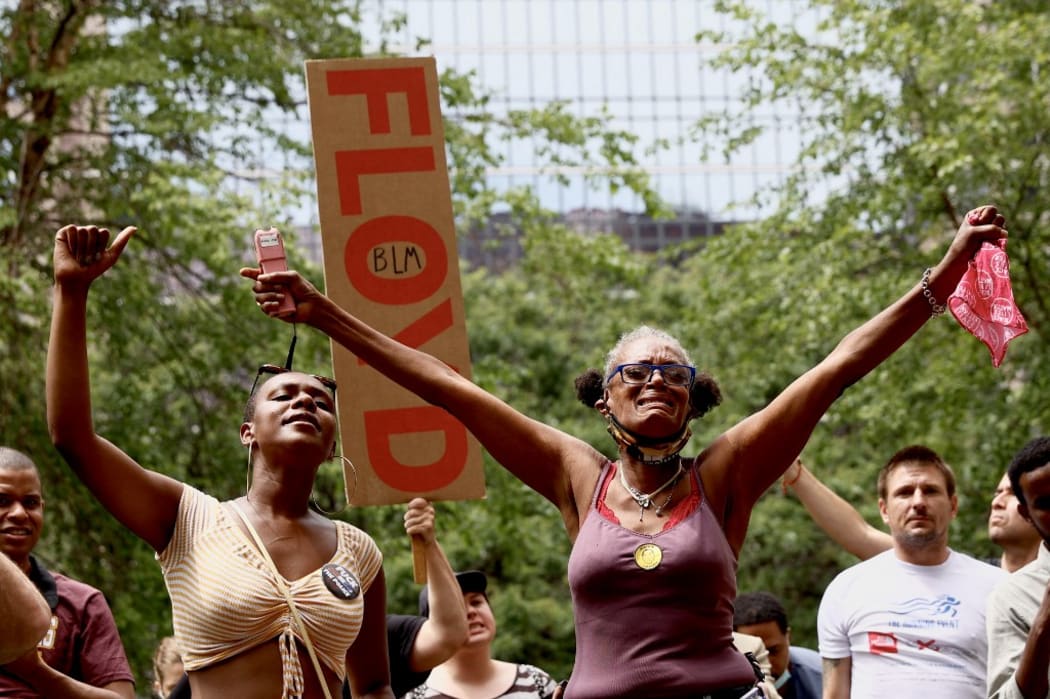 People react as they listen to the sentencing hearing of former Minneapolis Police officer Derek Chauvin outside the Hennepin County Government Center on June 25, 2021 in Minneapolis, Minnesota.