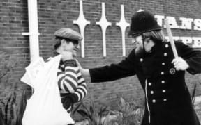 BLERTA actors Bruno Lawrence and Tony Barry ham it up in a keystone cops role, with the contents of the loot bag appearing to be copies of the controversial 70s underground magazine Cock.