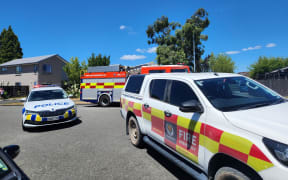 Two police cars and two fire trucks are at the scene of a house fire in the Christchurch suburb of Hornby.