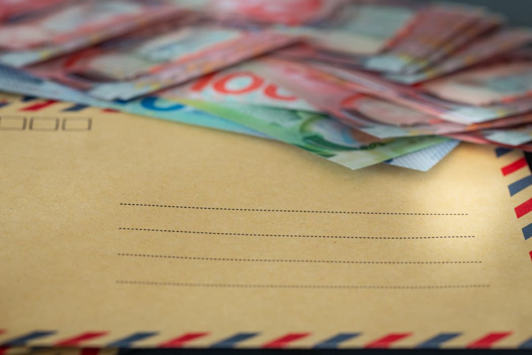 Piggy bank and a bundle of dollars from New Zealand. Money savings concept