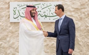 Saudi Crown Prince Mohammed bin Salman (L) shakes hands with Syria's President Bashar al-Assad on the sidelines of the Arab Summit meeting in Jeddah.