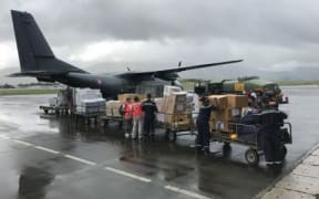 A French military plane is loaded with supplies bound for the cyclone-hit New Caledonia island of Lifou.