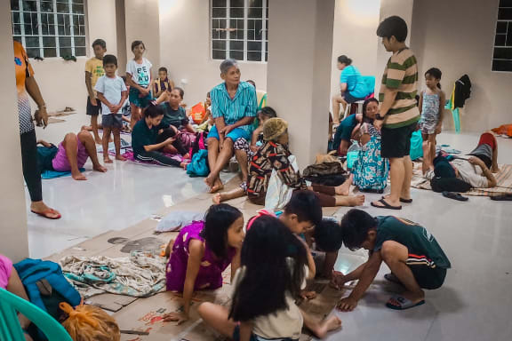 Residents rest in an evacuation centre, as typhoon Phanfone makes landfall, in Borongan, Eastern Samar province, central Philippines on December 24, 2019.