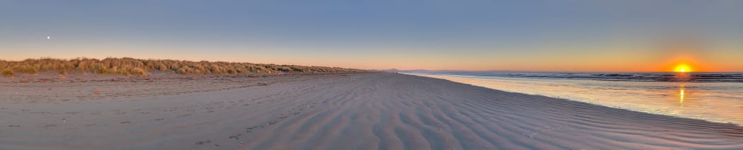 Panorama showing both the sun and the moon around the winter solstice (see also June solstice). South New Brighton's beach, New Zealand