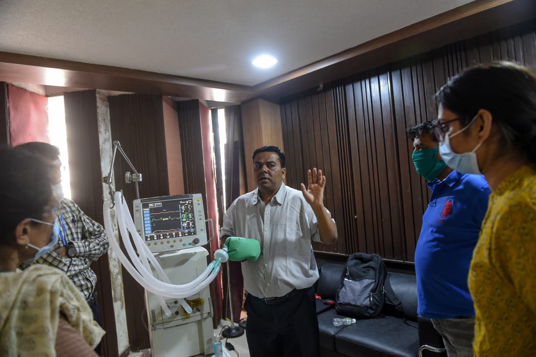 A doctor in India trains other health workers on using a ventilator, during the national lockdown.
