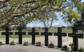 Crosses with the names and portraits of the victims of the 1999 Columbine High School massacre are seen at the Chapel Hill Memorial Gardens in Littleton, Colorado on April 20, 2019.