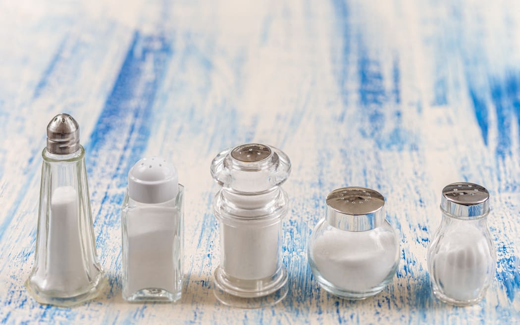 Salt shakers 
Fine salt under various transparent glass salt shakers aligned in the foreground. (Photo by CHASSENET / BSIP / BSIP via AFP)