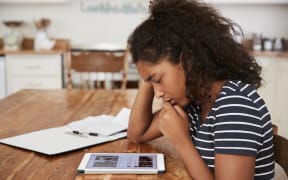 Teenage Girl At Home Using Digital Tablet Being Bullied On Line