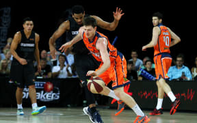 Corey Webster of the Breakers bodies up on Cameron Gliddon of the Taipans.