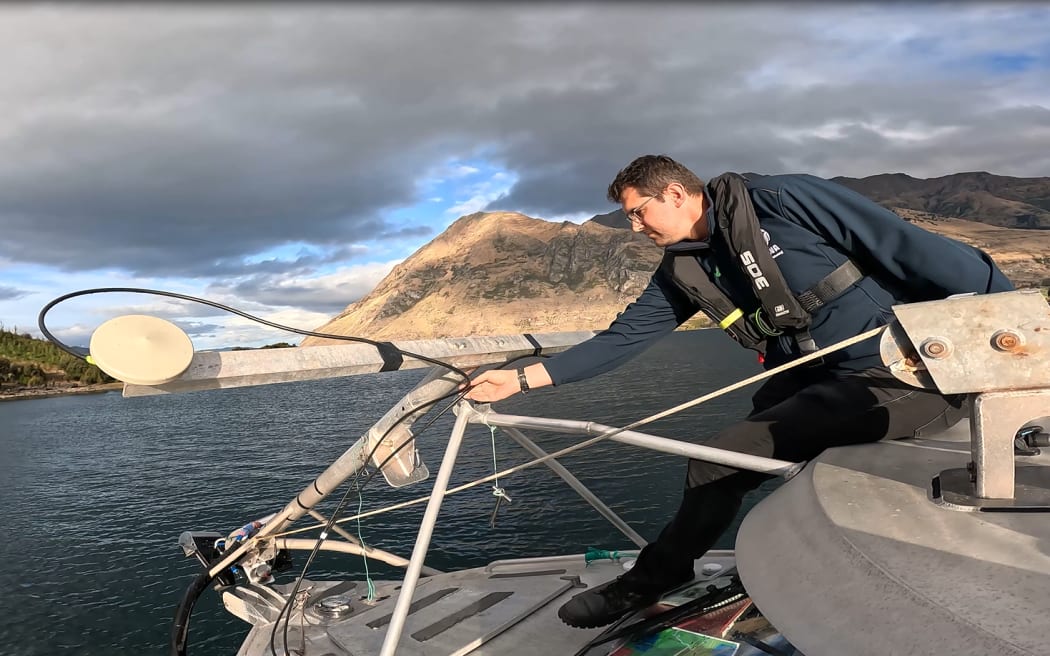 Lake Wānaka mapping project team onboard RV Rukuwai II with multibeam echosounder attached to the bow of the research vessel.