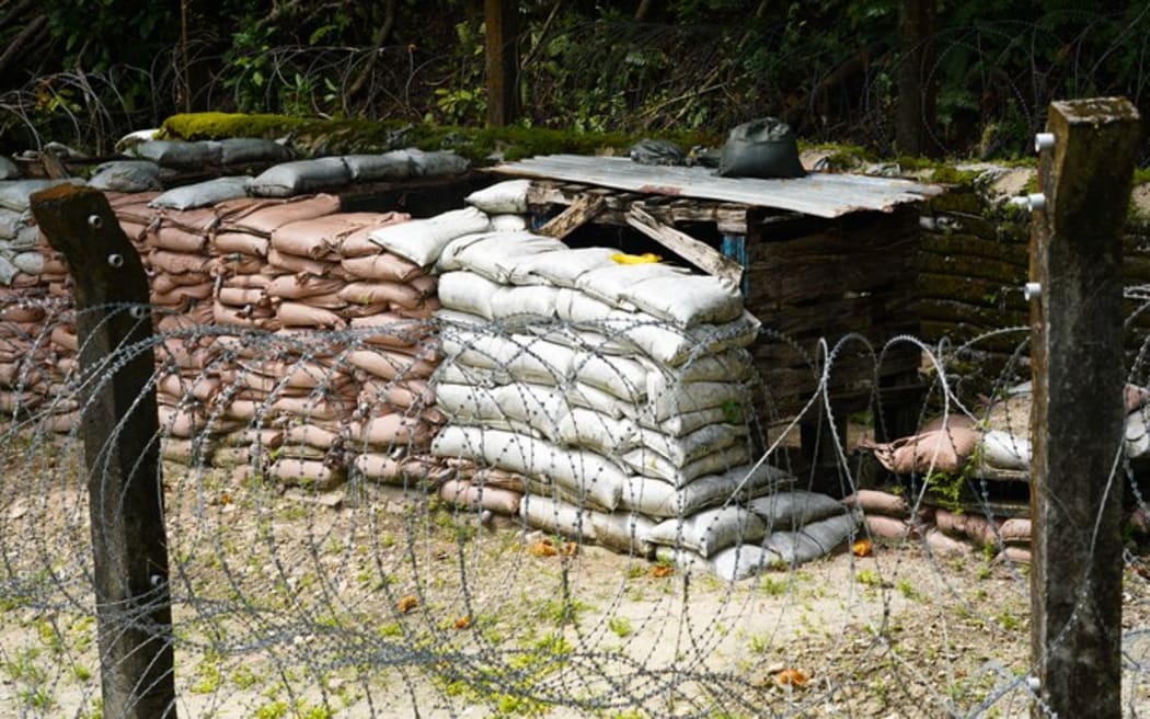 NPA's makeshift storage depot for unexploded ordnance is made up of sandbags, rotting wooden pallets and barbed wire in Peleliu, Palau, Nov. 26, 2024.