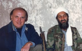 Former CNN reporter Peter Arnett poses with terrorist mastermind Osama bin Laden in March, 1997 after a television interview for CNN at Tora Bora, Afghanistan.
