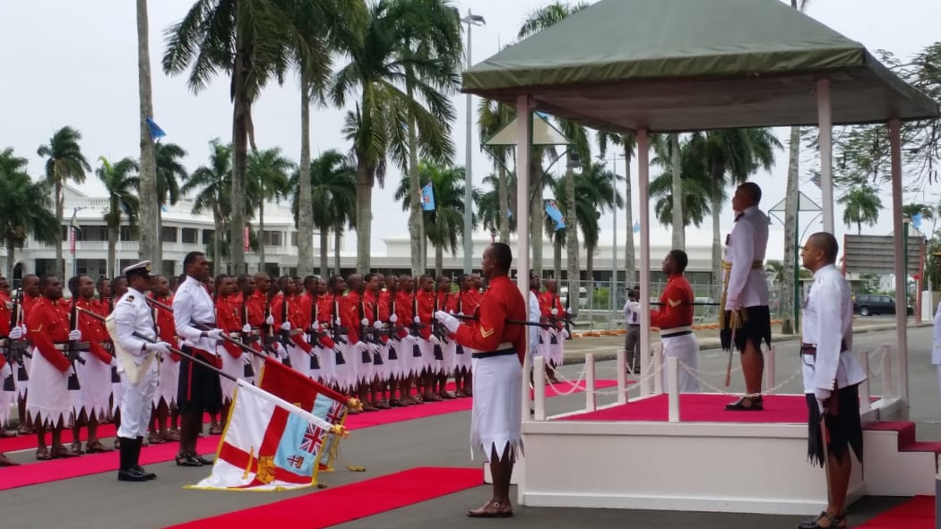 Fiji President Jioje Konrote salutes military as they play the national anthem.