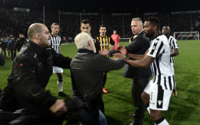 Paok president Ivan Savvidis takes to the pitch carrying a handgun in his waistband, after the referee refused a last minute goal on Sunday.