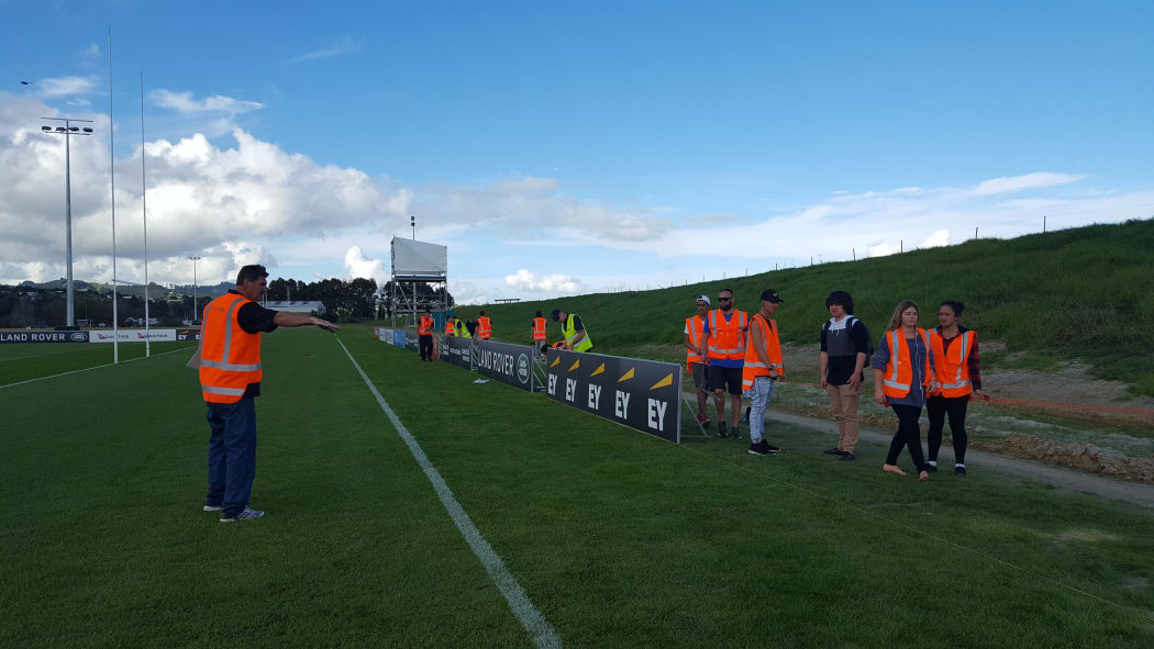 Signmaker Hayden Corliss directs trainees in set-up for the Lions training ground on Roverside Drive.