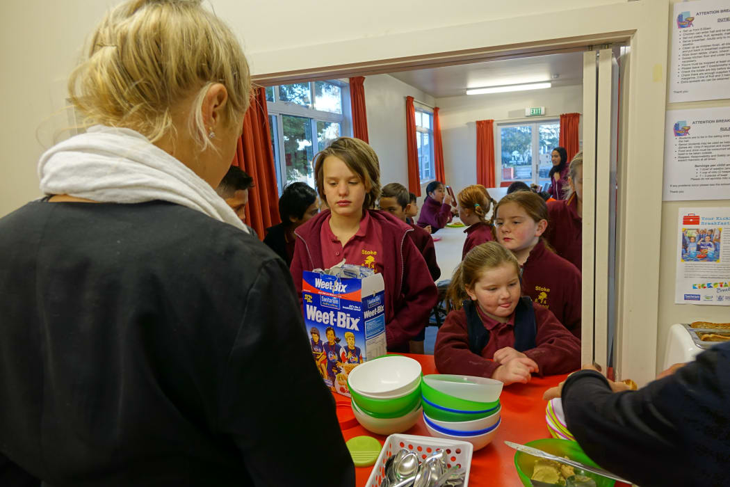 Breakfast club queue: Pupils at Stoke School line up for breakfast, provided free with the help of sponsorship and volunteers.
