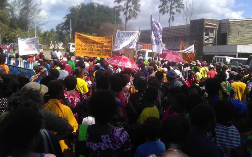 Protesters march through the centre of the PNG city of Madang to present a petition demanding better law and order.