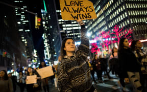 NEW YORK, NY - NOVEMBER 11: Anti-Donald Trump protesters march in the street on Fifth Avenue, November 11, 2016 in New York City. The election of Trump as president has sparked protests in cities across the country. Drew Angerer/Getty Images/AFP
