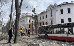 Ukrainian law enforcement officers work at the site of a missile attack in Sumy, northeastern Ukraine, on April 13, 2025, amid the Russian invasion of Ukraine. A Russian ballistic missile attack on Ukraine's northeastern city of Sumy killed at least 31 people and wounded 84 on Palm Sunday, Kyiv said, in another deadly attack on civilians that came after a top US official travelled to Russia. (Photo by Oleg VORONENKO / AFP)