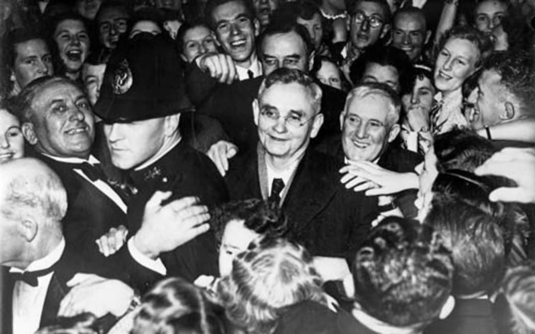 Michael Joseph Savage surrounded by fans during the 1938 election campaign, in the midst of our most famous national 'bounce back'