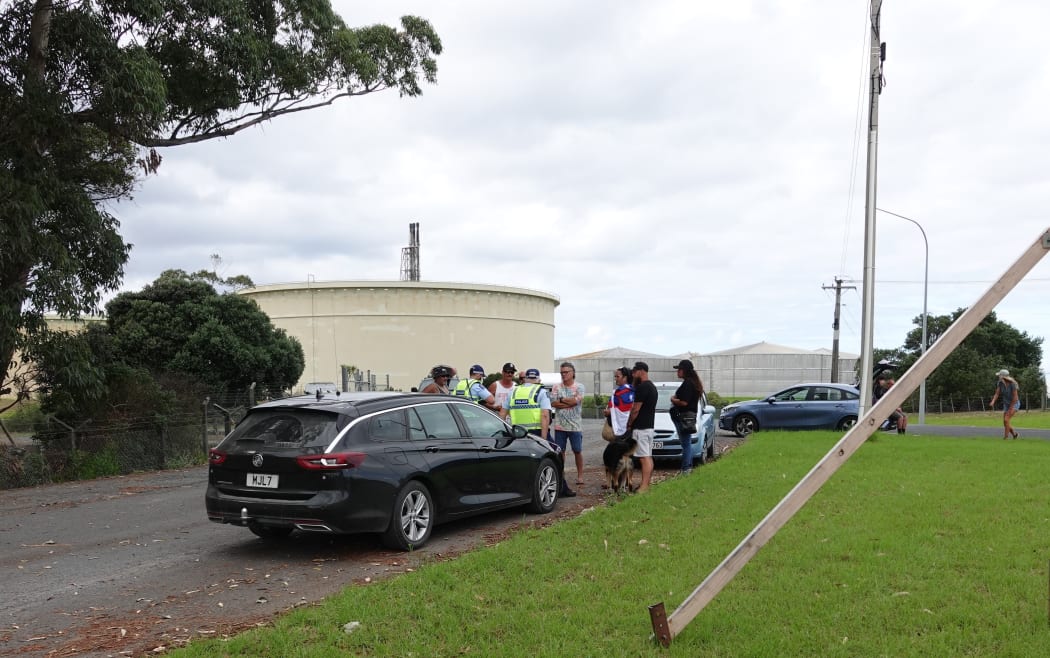 Protesters speaking with police this morning outside the former Marsden Point refinery.