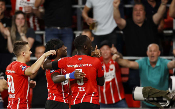 PSV Eindhoven New Zealand midfielder Ryan Thomas, and teammates English midfielder Noni Madueke, and Dutch defender Jordan Teze celebrate a goal during the Dutch Eredivisie match between PSV Eindhoven and SC Cambuur at Phillips stadium in Eindhoven on August 21, 2021.