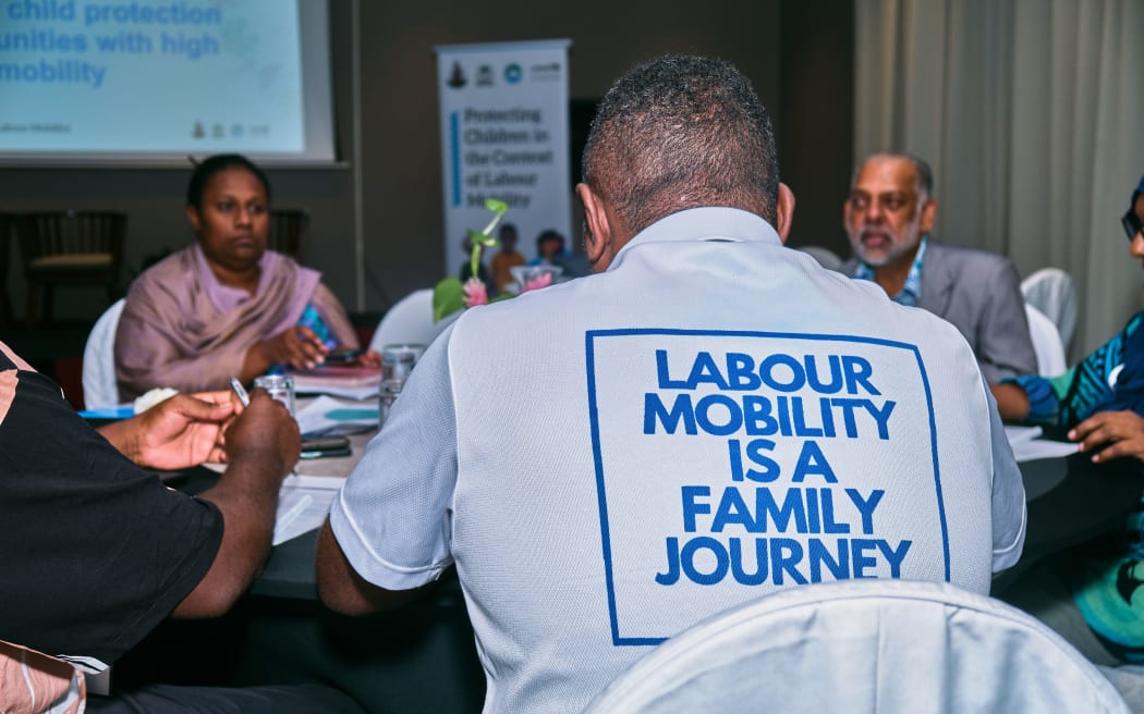 A participant from Vanuatu wearing a T-shirt that says 'Labour Mobility is a Family Journey' during the UNICEF Labour Mobility Conference on the 16th and 17th of July 2024 at Ramada, Port Vila.