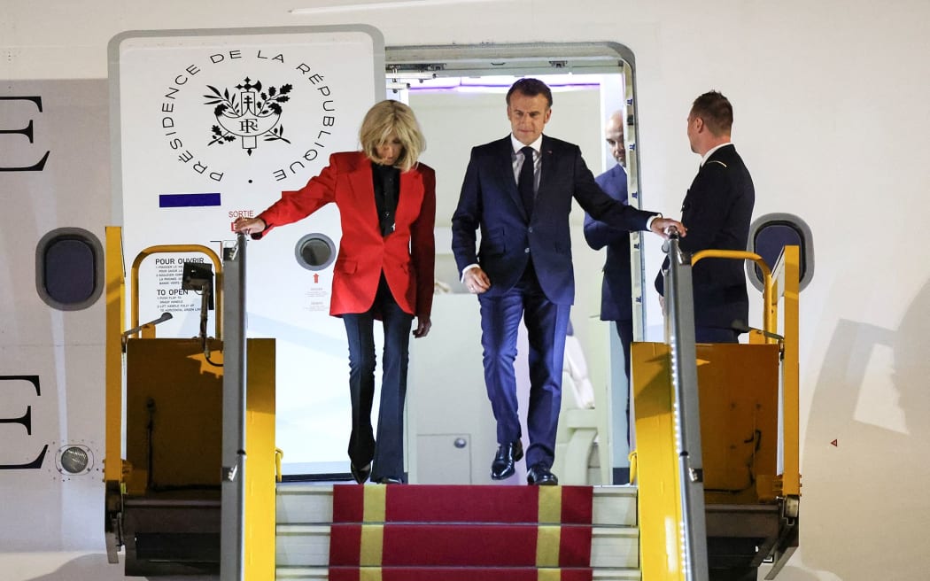 France's President Emmanuel Macron and his wife Brigitte Macron leave the plane at Noi Bai International Airport in Vietnam, shortly after the incident captured on video.