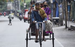 Passengers wearing mask on a rickshaw, during the ongoing COVID-19 nationwide lockdown, in Guwahati, Assam, India on Friday, 15 May 2020. (Photo by David Talukdar/NurPhoto)