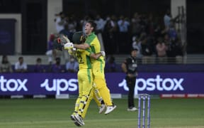 Australia's Glenn Maxwell (left) and Mitchell Marsh celebrate their win in the ICC men's Twenty20 World Cup final match between Australia and New Zealand at the Dubai International Cricket Stadium in Dubai on November 14, 2021.