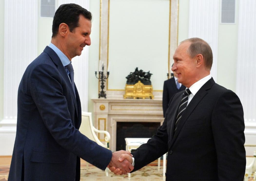 Vladimir Putin (R) shakes hands with his Bashar al-Assad during a meeting at the Kremlin in Moscow in October 2015.