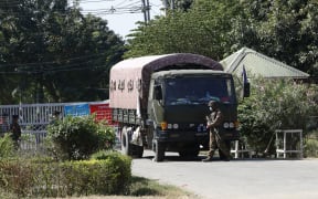 Military trucks loaded with soldiers take security at the entrance of Si Bin Guesthouse where members of parliament stay in Naypyidaw in Myanmar