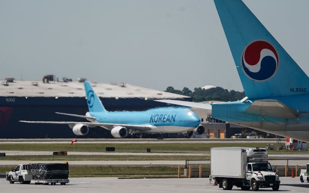 A Korean Air Boeing 747-8I from Seoul, to repatriate hundreds of South Korean workers who were detained in an immigration raid at a Hyundai-LG battery plant under construction in the US state of Georgia last week, is seen in the cargo area of Hartsfield-Jackson Atlanta International Airport in Atlanta, Georgia, on September 10, 2025. While no official time has been given for the return flight, the operation was the largest single-site raid conducted under US President Donald Trump's immigration crackdown, according to an investigating agent. (Photo by Elijah Nouvelage / AFP)