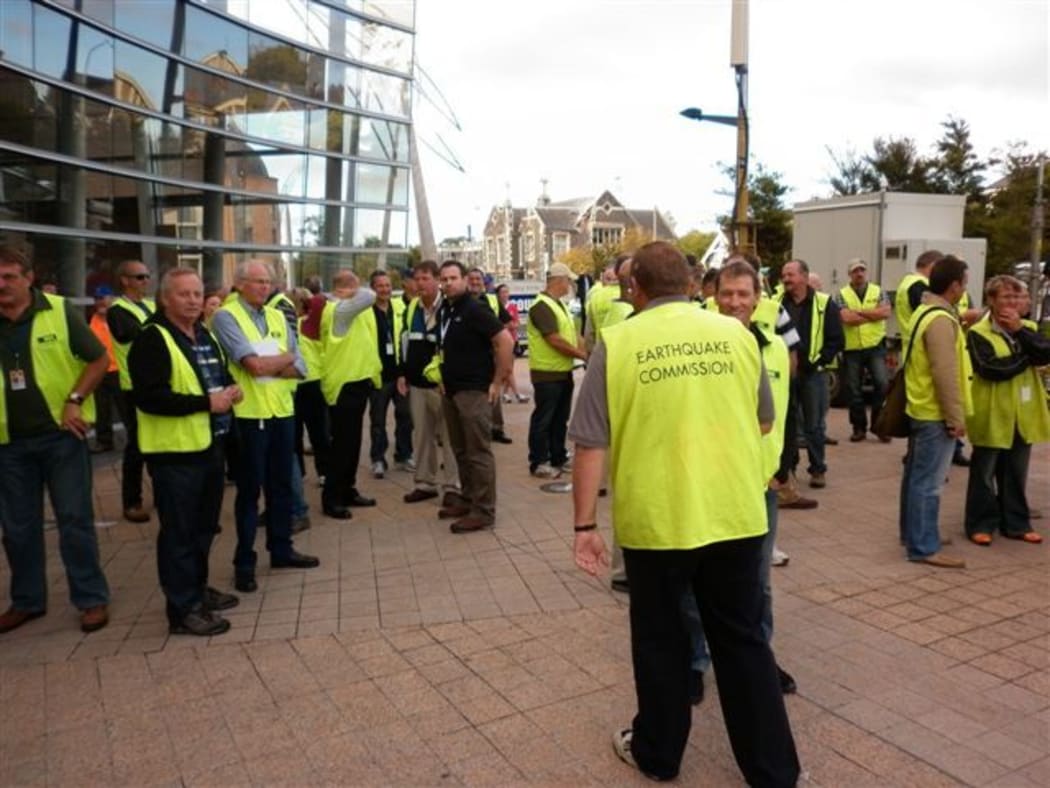 Earthquake Commission staff gather outside the Civil Defence headquarters on Thursday.