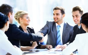 Men and women at an office meeting