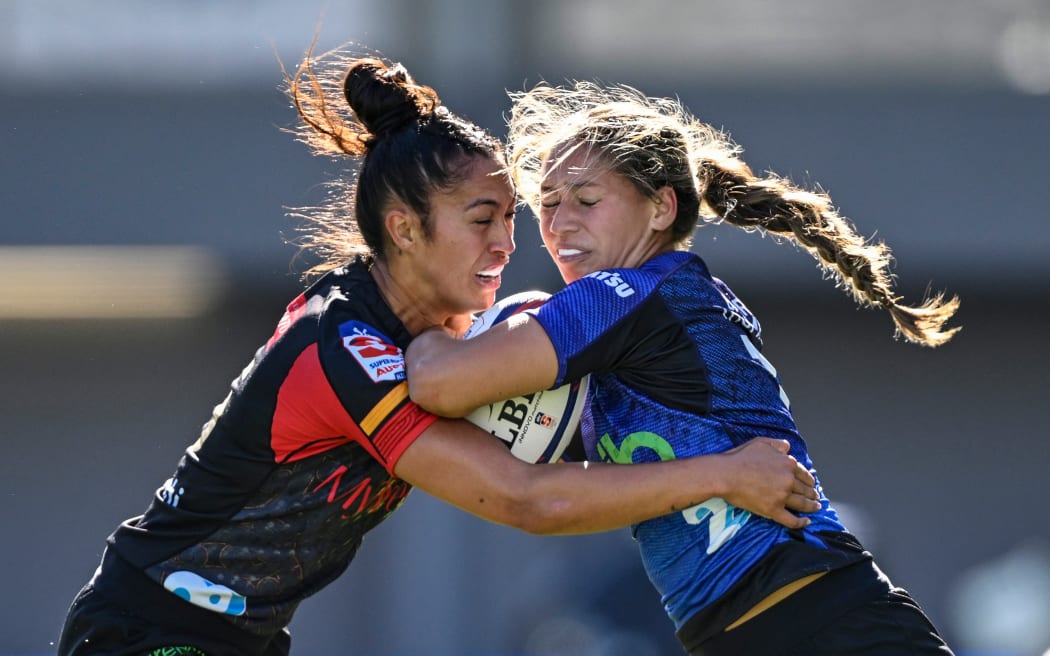 Tenika Willison of the Chiefs Manawa tackles Jaymie  Kolose of the Blues.