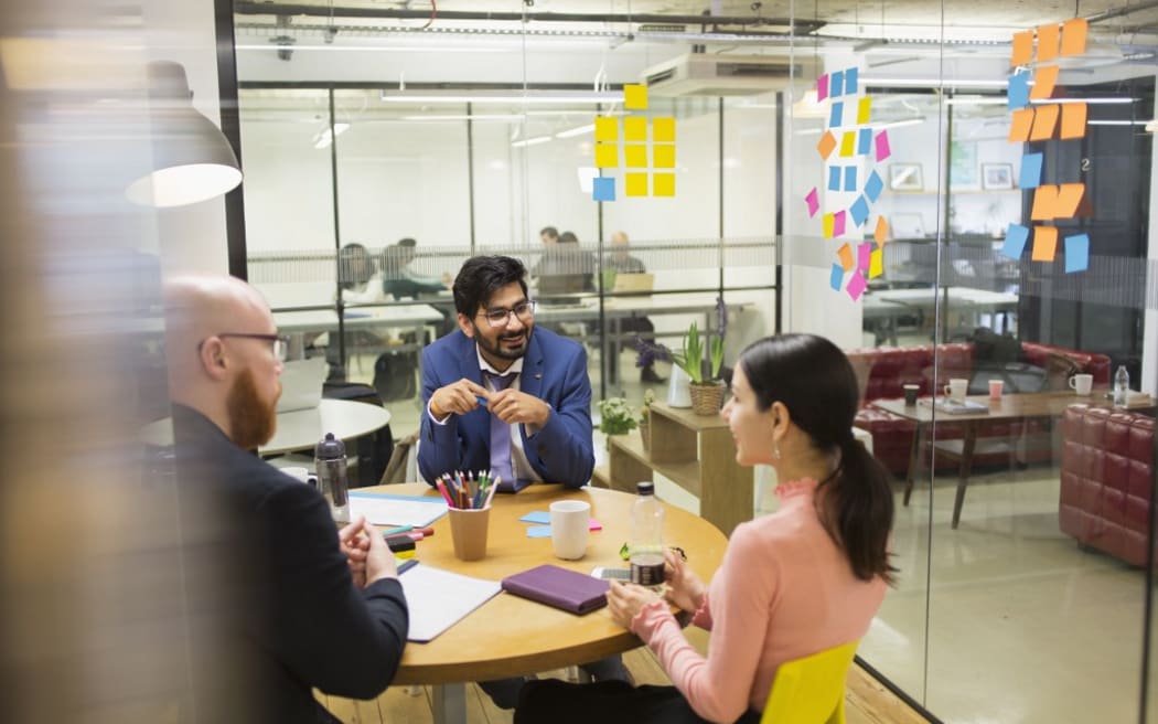 Creative business people brainstorming in conference room meeting.