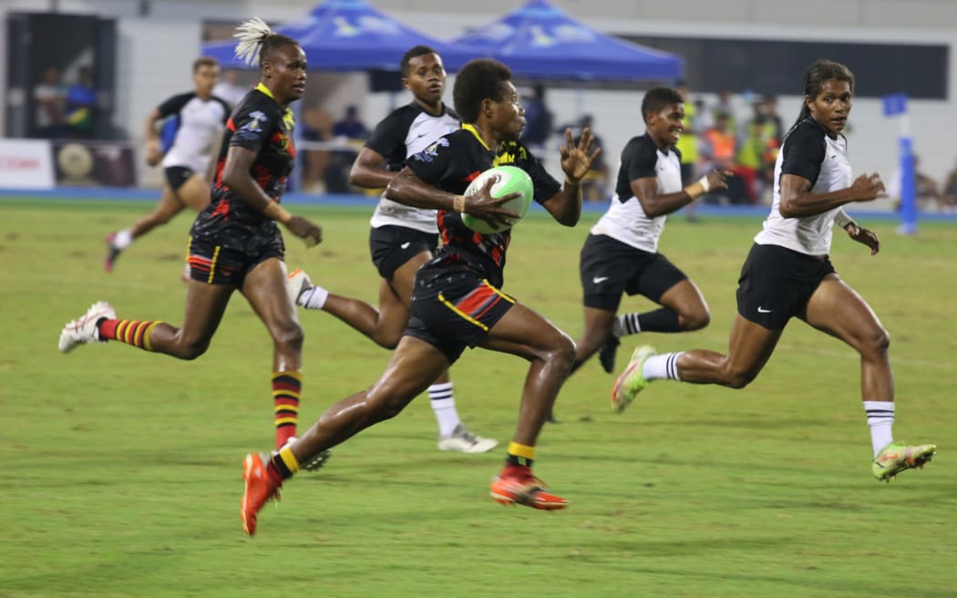 A Papua New Guinea women’s 7s player tries to make a break with the Fijian defence closing in during their Pacific Games finals match in Solomon Islands. Fulltime score Fiji 17 – 7 Papua New Guinea. 25 November 2023