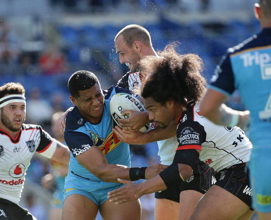 Titans forward Moeaki Fotuaika tests the Warriors defence.