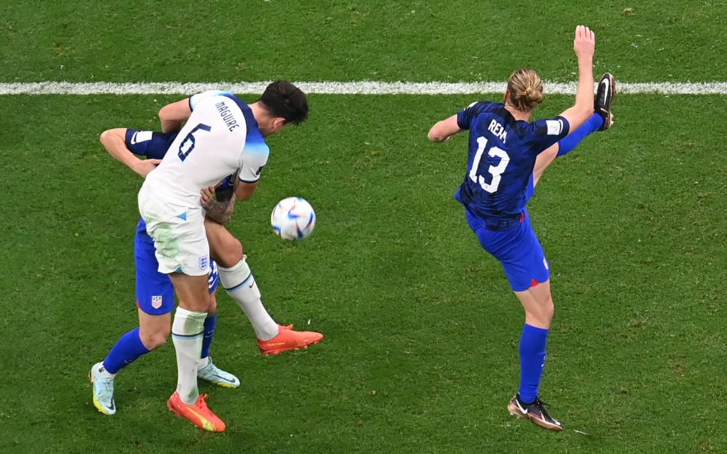England's defender #06 Harry Maguire (C) fights for the ball with USA's forward #24 Josh Sargent and USA's defender #13 Tim Ream during the Qatar 2022 World Cup Group B football match between England and USA at the Al-Bayt Stadium in Al Khor, north of Doha on November 25, 2022. (Photo by Kirill KUDRYAVTSEV / AFP)